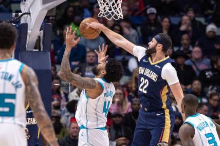 Jan 17, 2024; New Orleans, Louisiana, USA;  New Orleans Pelicans forward Larry Nance Jr. (22) blocks the shot of Charlotte Hornets center Nick Richards (4) during the first half at Smoothie King Center. Mandatory Credit: Stephen Lew-USA TODAY Sports