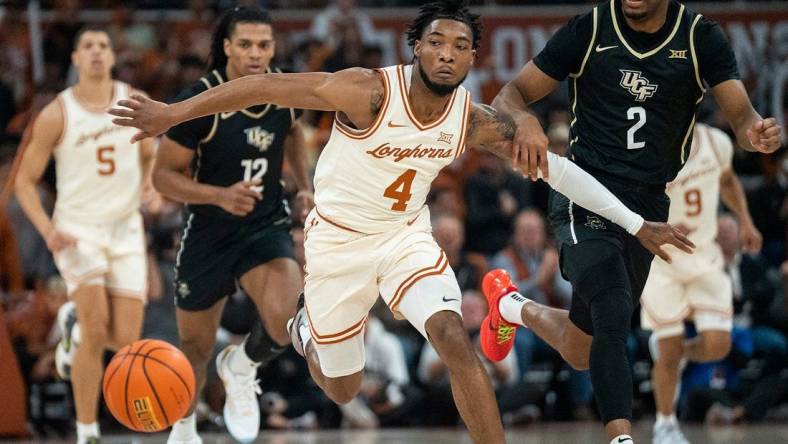 Texas Longhorns guard Tyrese Hunter (4) holds back UCF Knights guard Shemarri Allen (2) as they run after the ball during the game against University of Central Florida at the Moody center in Austin, Texas Wednesday, Jan. 17, 2023.