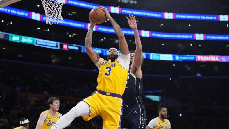 Jan 17, 2024; Los Angeles, California, USA; Los Angeles Lakers forward Anthony Davis (3) rebounds the ball against Dallas Mavericks center Dereck Lively II (2) in the first half at Crypto.com Arena. Mandatory Credit: Kirby Lee-USA TODAY Sports