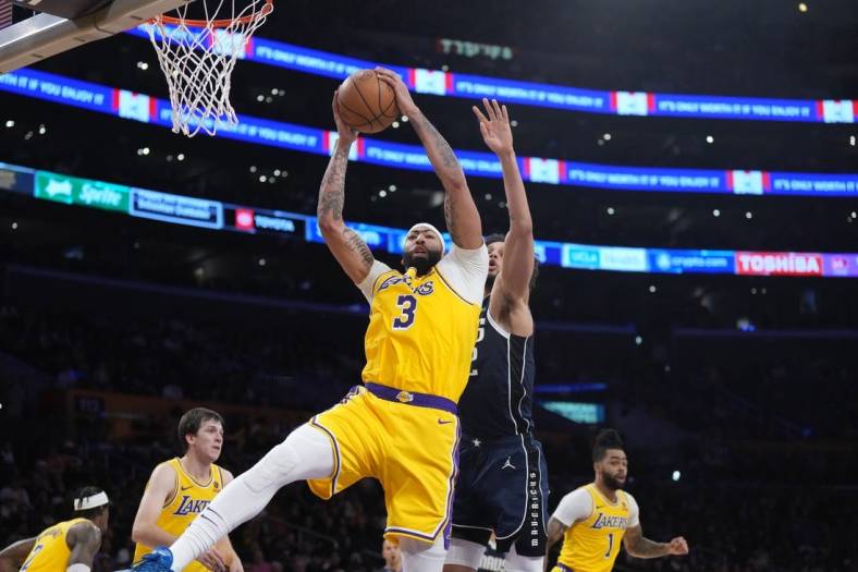 Jan 17, 2024; Los Angeles, California, USA; Los Angeles Lakers forward Anthony Davis (3) rebounds the ball against Dallas Mavericks center Dereck Lively II (2) in the first half at Crypto.com Arena. Mandatory Credit: Kirby Lee-USA TODAY Sports