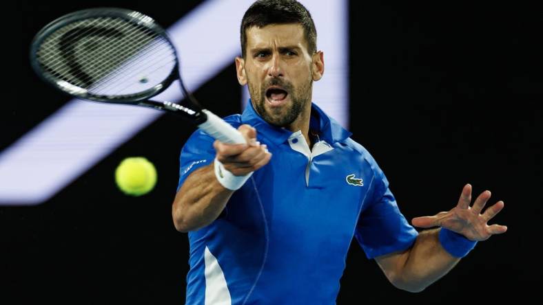 Jan 17, 2024; Melbourne, Victoria, Australia; Novak Djokovic Serbia plays a shot against Alexei Popyrin (not pictured) of Australia in Round 2 of the Men's Singles on Day 4 of the Australian Open tennis at Rod Laver Arena. Mandatory Credit: Mike Frey-USA TODAY Sports