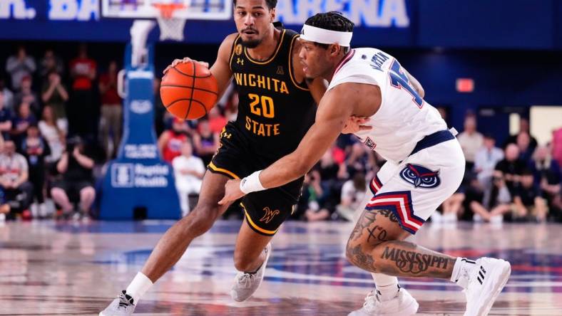 Jan 18, 2024; Boca Raton, Florida, USA; Wichita State Shockers guard Harlond Beverly (20) dribbles the ball against Florida Atlantic Owls guard Alijah Martin (15) during the first half at Eleanor R. Baldwin Arena. Mandatory Credit: Rich Storry-USA TODAY Sports