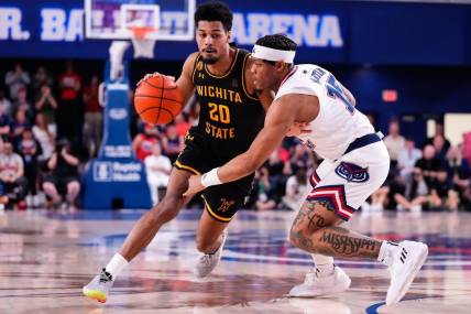 Jan 18, 2024; Boca Raton, Florida, USA; Wichita State Shockers guard Harlond Beverly (20) dribbles the ball against Florida Atlantic Owls guard Alijah Martin (15) during the first half at Eleanor R. Baldwin Arena. Mandatory Credit: Rich Storry-USA TODAY Sports