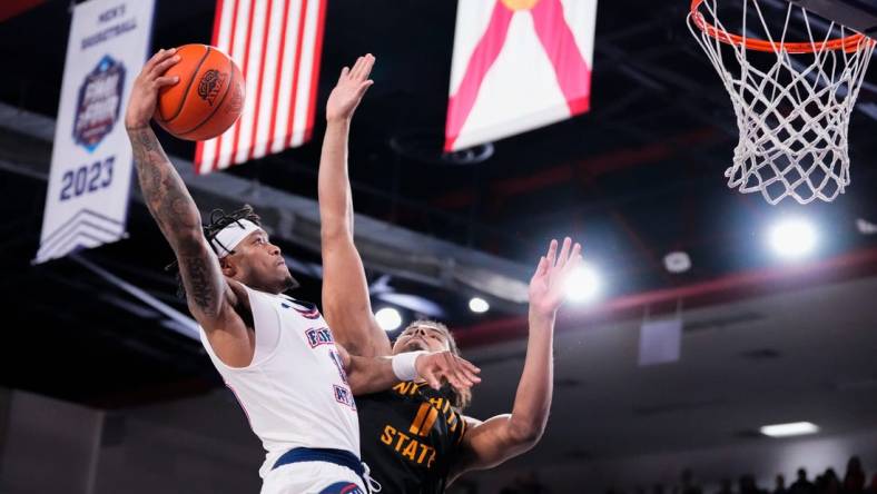 Jan 18, 2024; Boca Raton, Florida, USA; Florida Atlantic Owls guard Alijah Martin (15) goes up for a shot against Wichita State Shockers forward Kenny Pohto (11) during the second half at Eleanor R. Baldwin Arena. Mandatory Credit: Rich Storry-USA TODAY Sports