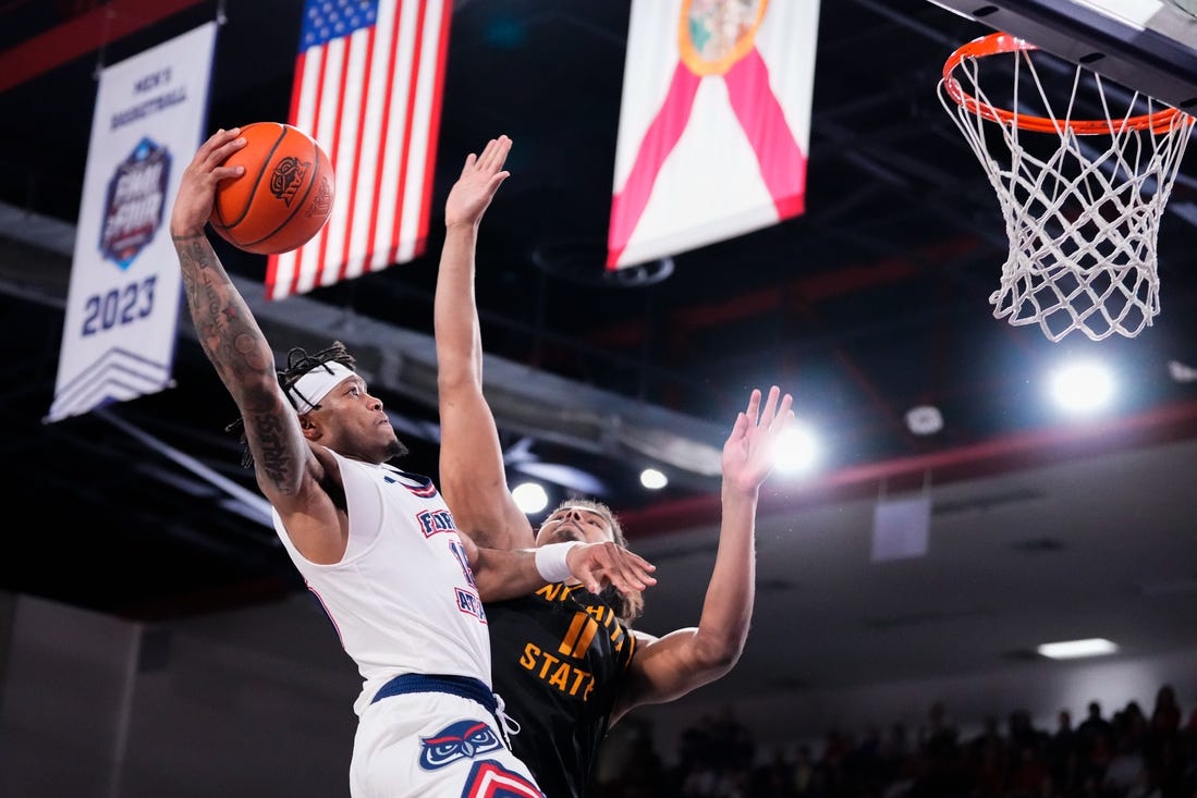 Jan 18, 2024; Boca Raton, Florida, USA; Florida Atlantic Owls guard Alijah Martin (15) goes up for a shot against Wichita State Shockers forward Kenny Pohto (11) during the second half at Eleanor R. Baldwin Arena. Mandatory Credit: Rich Storry-USA TODAY Sports