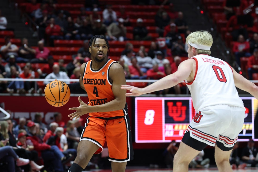 Jan 18, 2024; Salt Lake City, Utah, USA; Oregon State Beavers guard Dexter Akanno (4) looks to pass the ball on Utah Utes guard Hunter Erickson (0) during the first half at Jon M. Huntsman Center. Mandatory Credit: Rob Gray-USA TODAY Sports