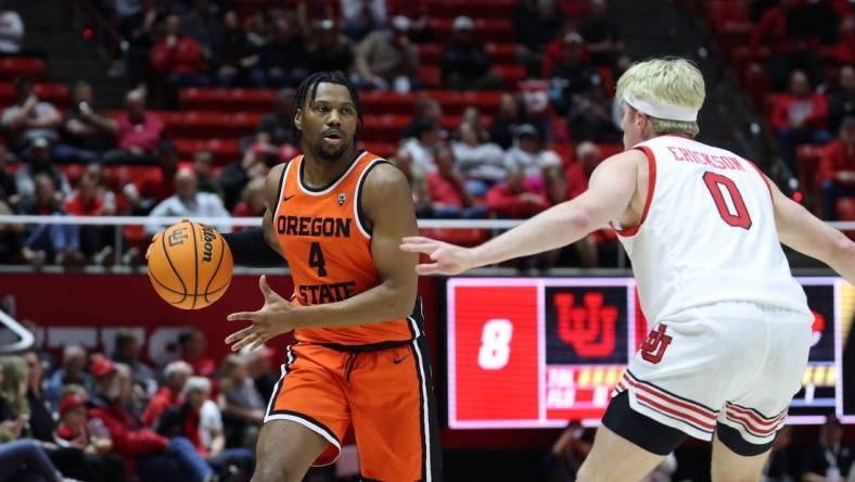 Jan 18, 2024; Salt Lake City, Utah, USA; Oregon State Beavers guard Dexter Akanno (4) looks to pass the ball on Utah Utes guard Hunter Erickson (0) during the first half at Jon M. Huntsman Center. Mandatory Credit: Rob Gray-USA TODAY Sports