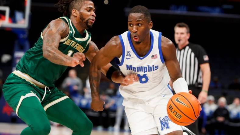 Jan 18, 2024; Memphis, Tennessee, USA; Memphis Tigers forward David Jones (8) drives to the basket against South Florida Bulls guard Selton Miguel (1) during the game between the University of South Florida and the University of Memphis at FedExForum. Mandatory Credit: Chris Day-USA TODAY Sports