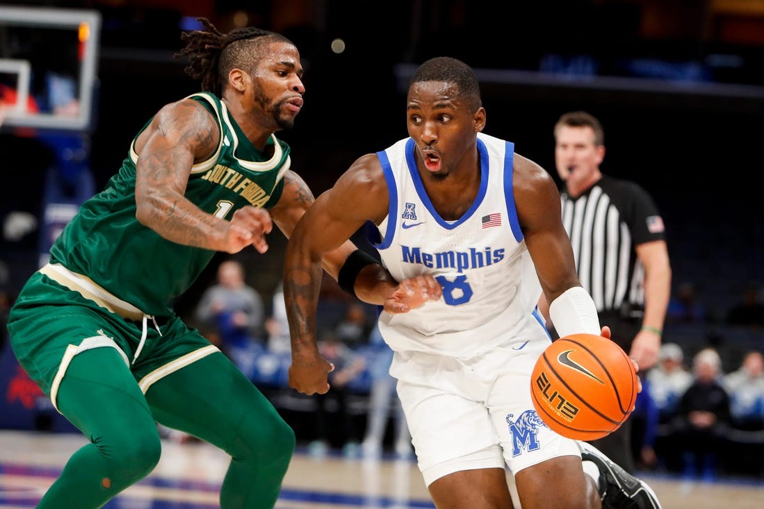 Jan 18, 2024; Memphis, Tennessee, USA; Memphis Tigers forward David Jones (8) drives to the basket against South Florida Bulls guard Selton Miguel (1) during the game between the University of South Florida and the University of Memphis at FedExForum. Mandatory Credit: Chris Day-USA TODAY Sports