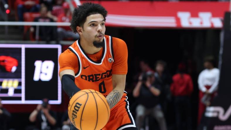 Jan 18, 2024; Salt Lake City, Utah, USA; Oregon State Beavers guard Jordan Pope (0) passes the ball against the Utah Utes during the first half at Jon M. Huntsman Center. Mandatory Credit: Rob Gray-USA TODAY Sports