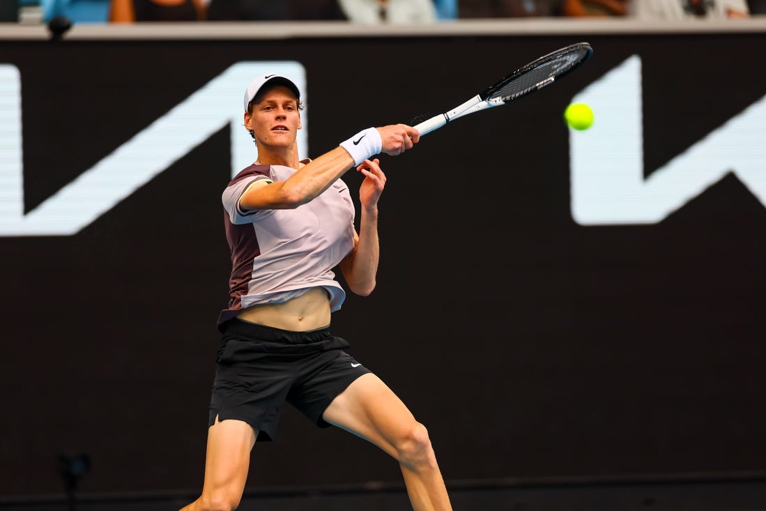 Jan 19, 2024; Melbourne, Victoria, Australia; Jannik Sinner of Italy plays a shot against Sebastian Baez (not pictured) of Argentina in Round 3 of the Men's Singles on Day 6 of the Australian Open tennis at Margaret Court Arena. Mandatory Credit: Mike Frey-USA TODAY Sports