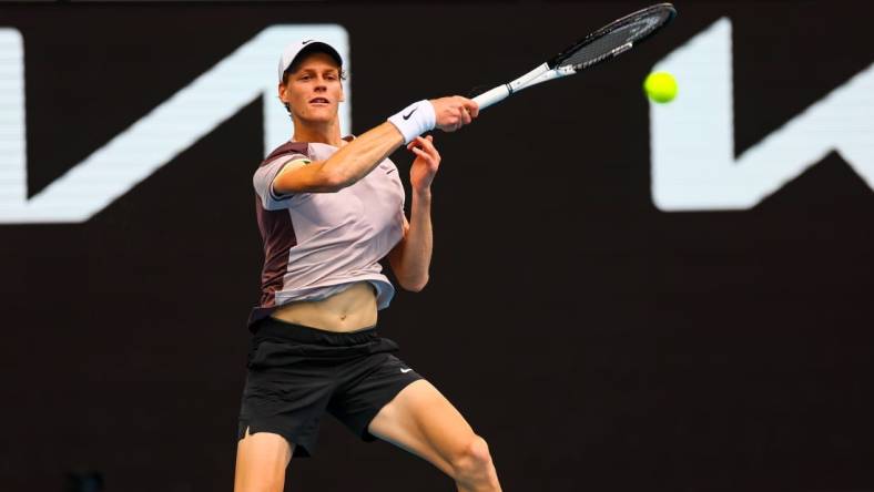 Jan 19, 2024; Melbourne, Victoria, Australia; Jannik Sinner of Italy plays a shot against Sebastian Baez (not pictured) of Argentina in Round 3 of the Men's Singles on Day 6 of the Australian Open tennis at Margaret Court Arena. Mandatory Credit: Mike Frey-USA TODAY Sports