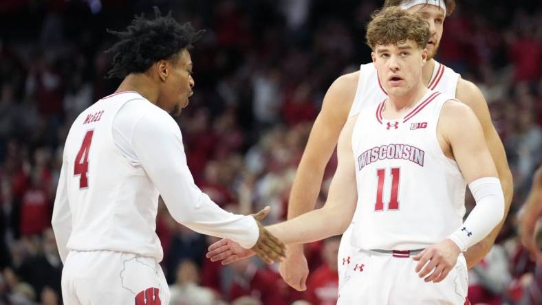 Jan 19, 2024; Madison, Wisconsin, USA; Wisconsin Badgers guard Max Klesmit (11) celebrates a three point basket with Wisconsin Badgers guard Kamari McGee (4) during the second half against the Indiana Hoosiers at the Kohl Center. Mandatory Credit: Kayla Wolf-USA TODAY Sports