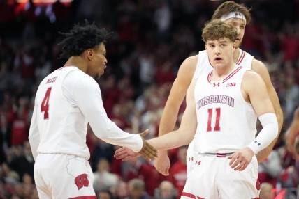 Jan 19, 2024; Madison, Wisconsin, USA; Wisconsin Badgers guard Max Klesmit (11) celebrates a three point basket with Wisconsin Badgers guard Kamari McGee (4) during the second half against the Indiana Hoosiers at the Kohl Center. Mandatory Credit: Kayla Wolf-USA TODAY Sports