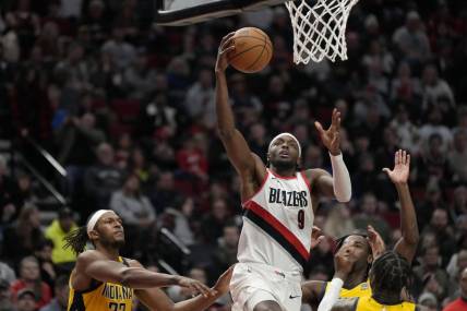 Jan 19, 2024; Portland, Oregon, USA; Portland Trail Blazers small forward Jerami Grant (9) shoots the ball past Indiana Pacers small forward Aaron Nesmith (23, right) during the second half at Moda Center. Mandatory Credit: Soobum Im-USA TODAY Sports