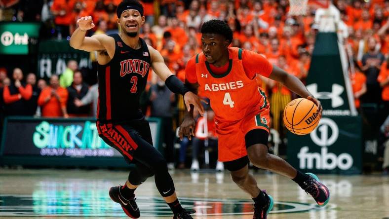 Jan 19, 2024; Fort Collins, Colorado, USA; Colorado State Rams guard Isaiah Stevens (4) controls the ball as UNLV Rebels guard Justin Webster (2) guards in the second half at Moby Arena. Mandatory Credit: Isaiah J. Downing-USA TODAY Sports