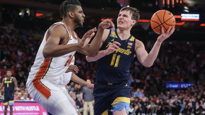 Jan 20, 2024; New York, New York, USA;  Marquette Golden Eagles guard Tyler Kolek (11) looks to drive past St. John's Red Storm forward Zuby Ejiofor (24) in the first half at Madison Square Garden. Mandatory Credit: Wendell Cruz-USA TODAY Sports