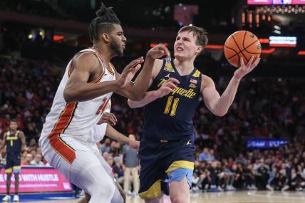 Jan 20, 2024; New York, New York, USA;  Marquette Golden Eagles guard Tyler Kolek (11) looks to drive past St. John's Red Storm forward Zuby Ejiofor (24) in the first half at Madison Square Garden. Mandatory Credit: Wendell Cruz-USA TODAY Sports