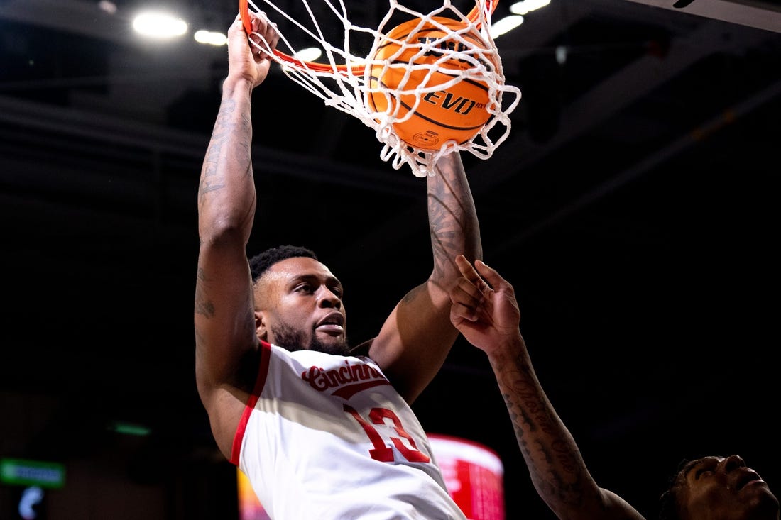 Cincinnati Bearcats forward Jamille Reynolds (13) dunks on Oklahoma Sooners forward Jalon Moore (14) in the first half of the NCAA basketball game between Cincinnati Bearcats and Oklahoma Sooners at Fifth Third Arena in Cincinnati on Saturday, Jan. 20, 2024.