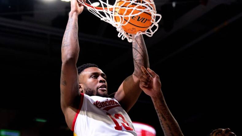 Cincinnati Bearcats forward Jamille Reynolds (13) dunks on Oklahoma Sooners forward Jalon Moore (14) in the first half of the NCAA basketball game between Cincinnati Bearcats and Oklahoma Sooners at Fifth Third Arena in Cincinnati on Saturday, Jan. 20, 2024.