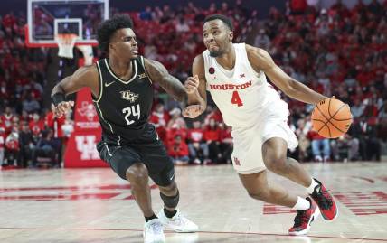 Jan 20, 2024; Houston, Texas, USA; Houston Cougars guard L.J. Cryer (4) drives with the ball as UCF Knights guard Jaylin Sellers (24) defends during the first half at Fertitta Center. Mandatory Credit: Troy Taormina-USA TODAY Sports
