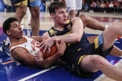 Jan 20, 2024; New York, New York, USA;  St. John's Red Storm guard RJ Luis Jr. (12) and Marquette Golden Eagles guard Tyler Kolek (11) fight for a loose ball in the second half at Madison Square Garden. Mandatory Credit: Wendell Cruz-USA TODAY Sports