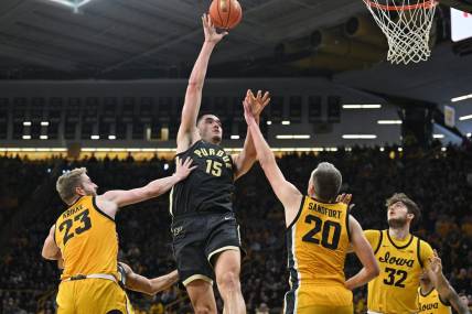 Jan 20, 2024; Iowa City, Iowa, USA; Purdue Boilermakers center Zach Edey (15) shoots the ball over Iowa Hawkeyes forward Ben Krikke (23) and forward Payton Sandfort (20) and forward Owen Freeman (32) during the second half at Carver-Hawkeye Arena. Mandatory Credit: Jeffrey Becker-USA TODAY Sports