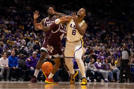 Jan 20, 2024; Baton Rouge, Louisiana, USA;  Texas A&M Aggies guard Wade Taylor IV (4) blocks the shot of LSU Tigers guard Jordan Wright (6) during the first half at Pete Maravich Assembly Center. Mandatory Credit: Stephen Lew-USA TODAY Sports