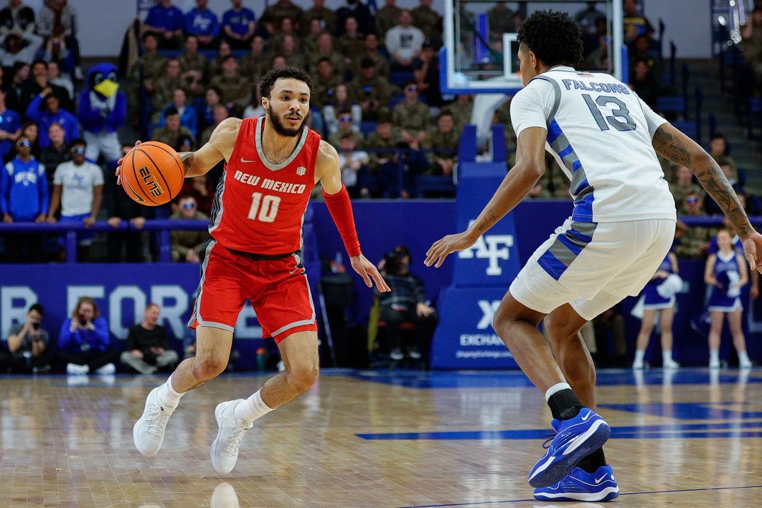 Jan 20, 2024; Colorado Springs, Colorado, USA; New Mexico Lobos guard Jaelen House (10) controls the ball as Air Force Falcons forward Chase Beasley (13) guards in the first half at Clune Arena. Mandatory Credit: Isaiah J. Downing-USA TODAY Sports