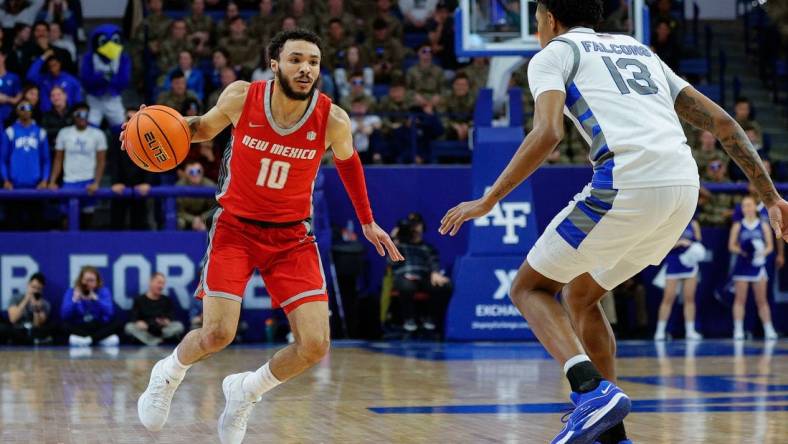 Jan 20, 2024; Colorado Springs, Colorado, USA; New Mexico Lobos guard Jaelen House (10) controls the ball as Air Force Falcons forward Chase Beasley (13) guards in the first half at Clune Arena. Mandatory Credit: Isaiah J. Downing-USA TODAY Sports