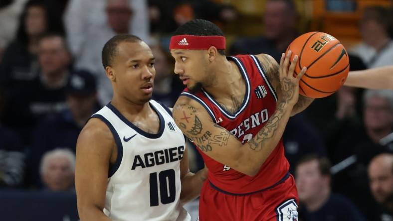 Jan 20, 2024; Logan, Utah, USA; Fresno State Bulldogs guard Isaiah Hill (3) looks to move the ball against Utah State Aggies guard Darius Brown II (10) during the first half at Dee Glen Smith Spectrum. Mandatory Credit: Rob Gray-USA TODAY Sports