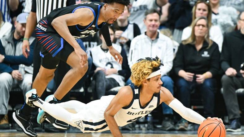 Jan 20, 2024; Indianapolis, Indiana, USA;  Butler Bulldogs guard DJ Davis (4) dives for the ball in front of DePaul Blue Demons forward Jeremiah Oden (25) during the first half at Hinkle Fieldhouse. Mandatory Credit: Robert Goddin-USA TODAY Sports