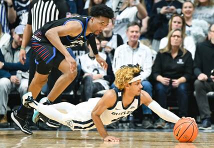 Jan 20, 2024; Indianapolis, Indiana, USA;  Butler Bulldogs guard DJ Davis (4) dives for the ball in front of DePaul Blue Demons forward Jeremiah Oden (25) during the first half at Hinkle Fieldhouse. Mandatory Credit: Robert Goddin-USA TODAY Sports