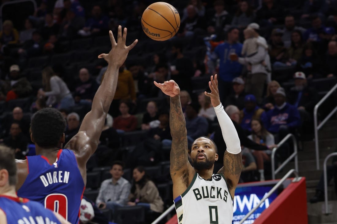 Jan 20, 2024; Detroit, Michigan, USA;  Milwaukee Bucks guard Damian Lillard (0) shoots on Detroit Pistons center Jalen Duren (0) in the second half at Little Caesars Arena. Mandatory Credit: Rick Osentoski-USA TODAY Sports