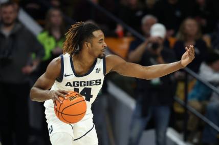 Jan 20, 2024; Logan, Utah, USA; Utah State Aggies guard Josh Uduje (14) calls a play against the Fresno State Bulldogs during the second half at Dee Glen Smith Spectrum. Mandatory Credit: Rob Gray-USA TODAY Sports