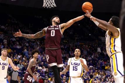 Jan 20, 2024; Baton Rouge, Louisiana, USA;  LSU Tigers guard Jordan Wright (6) knocks the rebound away from Texas A&M Aggies guard Jace Carter (0) during the second half at Pete Maravich Assembly Center. Mandatory Credit: Stephen Lew-USA TODAY Sports