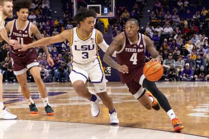 Jan 20, 2024; Baton Rouge, Louisiana, USA;  Texas A&M Aggies guard Wade Taylor IV (4) dribbles against LSU Tigers guard Jalen Cook (3) during the second half at Pete Maravich Assembly Center. Mandatory Credit: Stephen Lew-USA TODAY Sports