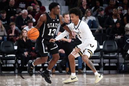 Jan 20, 2024; Starkville, Mississippi, USA; Mississippi State Bulldogs guard Josh Hubbard (13) dribbles as Vanderbilt Commodores guard Paul Lewis (3) defends during the second half at Humphrey Coliseum. Mandatory Credit: Petre Thomas-USA TODAY Sports