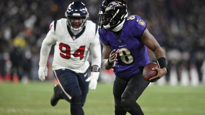 Jan 20, 2024; Baltimore, MD, USA; Baltimore Ravens quarterback Lamar Jackson (8) runs the ball to score a touchdown against Houston Texans defensive tackle Khalil Davis (94) during the fourth quarter of a 2024 AFC divisional round game at M&T Bank Stadium. Mandatory Credit: Tommy Gilligan-USA TODAY Sports