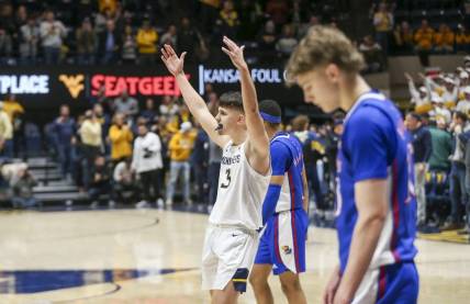 Jan 20, 2024; Morgantown, West Virginia, USA; West Virginia Mountaineers guard Kerr Kriisa (3) celebrates late in the second half against the Kansas Jayhawks at WVU Coliseum. Mandatory Credit: Ben Queen-USA TODAY Sports