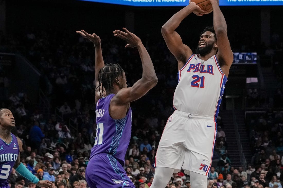 Jan 20, 2024; Charlotte, North Carolina, USA; Philadelphia 76ers center Joel Embiid (21) shoots over Charlotte Hornets center Nathan Mensah (31)during the second quarter at Spectrum Center. Mandatory Credit: Jim Dedmon-USA TODAY Sports