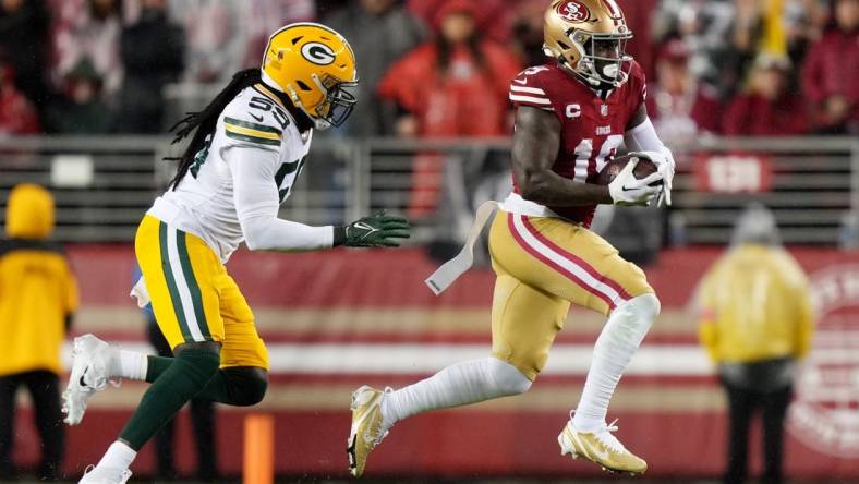 January 20, 2024; Santa Clara, CA, USA; San Francisco 49ers wide receiver Deebo Samuel (19) runs against Green Bay Packers linebacker De'Vondre Campbell (59) during the first quarter in a 2024 NFC divisional round game at Levi's Stadium. Mandatory Credit: Kyle Terada-USA TODAY Sports