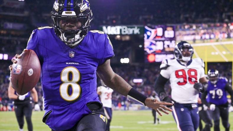 Jan 20, 2024; Baltimore, MD, USA; Baltimore Ravens quarterback Lamar Jackson (8) reacts after running past for Houston Texans defensive tackle Sheldon Rankins (98) for a touchdown during the fourth quarter  in a 2024 AFC divisional round game at M&T Bank Stadium. Mandatory Credit: Tommy Gilligan-USA TODAY Sports