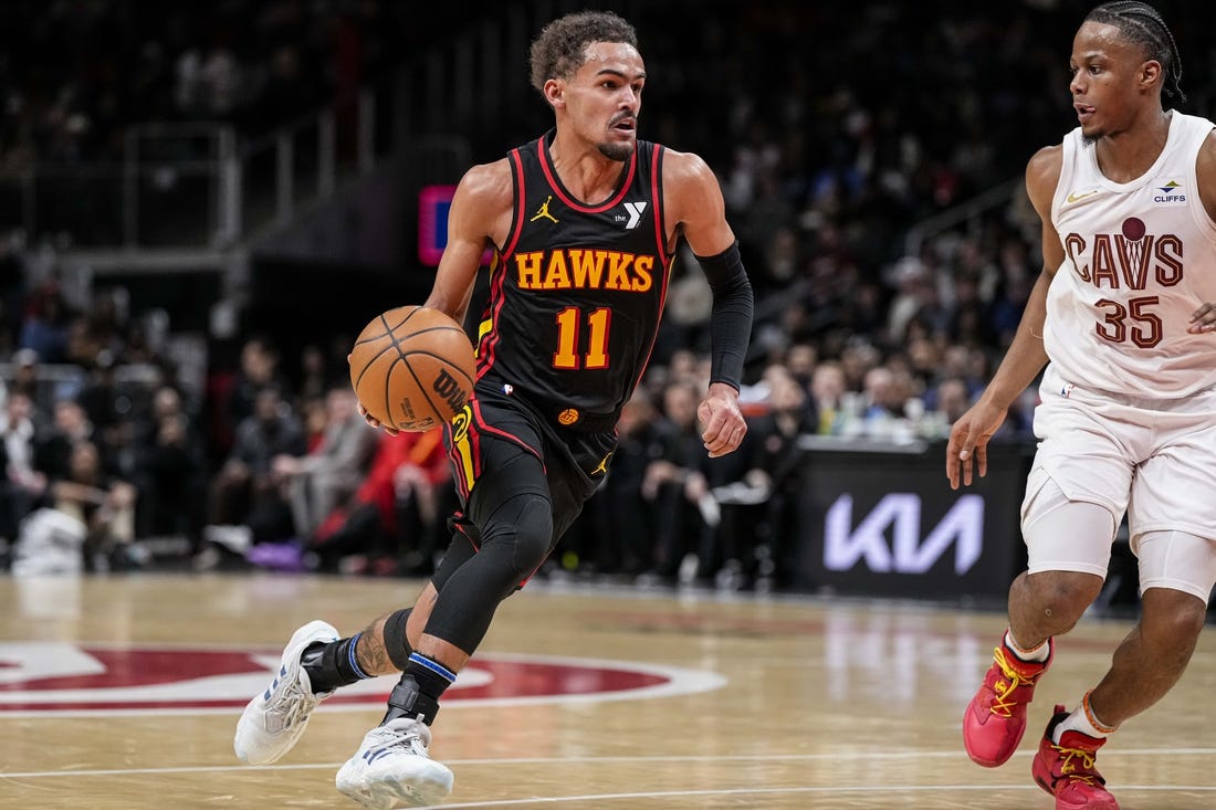 Jan 20, 2024; Atlanta, Georgia, USA; Atlanta Hawks guard Trae Young (11) dribbles against Cleveland Cavaliers forward Isaac Okoro (35) during the second half at State Farm Arena. Mandatory Credit: Dale Zanine-USA TODAY Sports