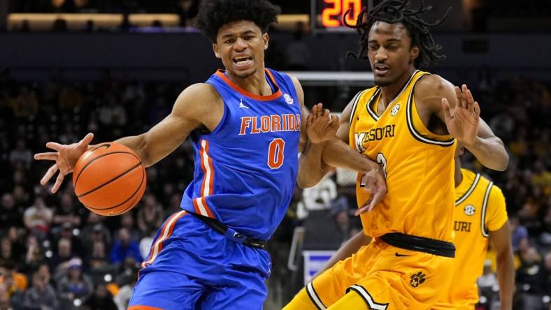 Jan 20, 2024; Columbia, Missouri, USA; Florida Gators guard Zyon Pullin (0) drives against Missouri Tigers forward Aidan Shaw (23) during the second half at Mizzou Arena. Mandatory Credit: Jay Biggerstaff-USA TODAY Sports