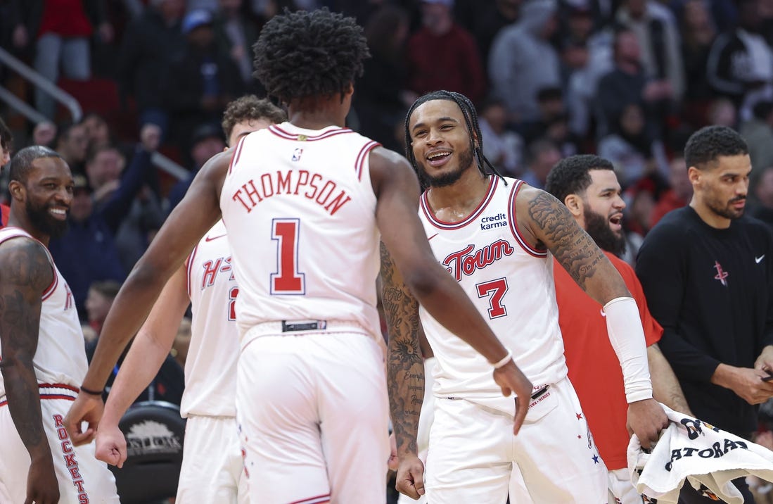 Jan 20, 2024; Houston, Texas, USA; Houston Rockets forward Cam Whitmore (7) celebrates with forward Amen Thompson (1) after a play during overtime against the Utah Jazz at Toyota Center. Mandatory Credit: Troy Taormina-USA TODAY Sports