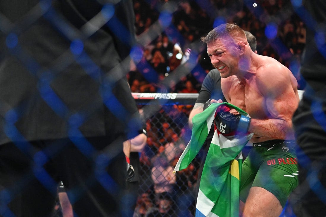 Jan 20, 2024; Toronto, Canada, USA; Dricus Du Plessis (blue gloves) celebrates defeating Sean Strickland (red glove) during UFC 297 at ScotiaBank Arena. Mandatory Credit: Dan Hamilton-USA TODAY Sports