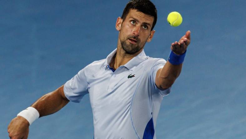 Jan 21, 2024; Melbourne, Victoria, Australia; Novak Djokovic of Serbia hits a shot against Adrian Mannarino of France in the forth round of the men s singles at the Australian Open 2024. Mandatory Credit: Mike Frey-USA TODAY Sports