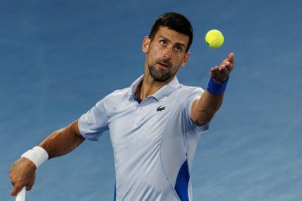 Jan 21, 2024; Melbourne, Victoria, Australia; Novak Djokovic of Serbia hits a shot against Adrian Mannarino of France in the forth round of the men s singles at the Australian Open 2024. Mandatory Credit: Mike Frey-USA TODAY Sports