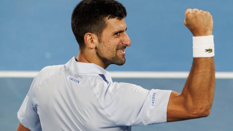 Jan 21, 2024; Melbourne, Victoria, Australia; Novak Djokovic of Serbia celebrates his victory over Adrian Mannarino of France in the forth round of the men s singles at the Australian Open 2024. Mandatory Credit: Mike Frey-USA TODAY Sports